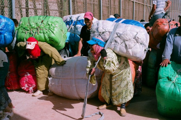 Women carry heavy loads on foot across the border from Spanish enclaves to Morocco. Courtesy: Cortesía de José Palazón/Asociación Pro Derechos Humanos de la Infancia