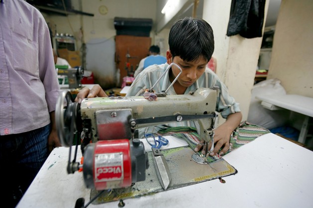 A child labours at a sweatshop in India. Credit: photo stock