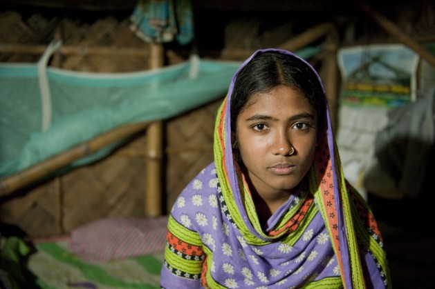 Fatema,15, sits on the bed at her home in Khulna, Bangladesh, in April 2014. Fatema was saved from being married a few weeks earlier. Local child protection committee members stopped the marriage with the help of law enforcement agencies. Credit: UNICEF