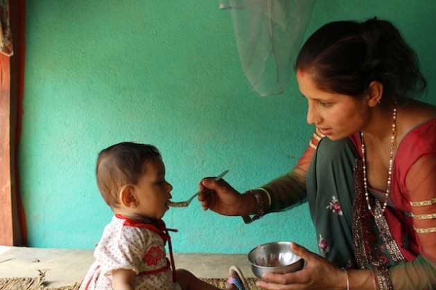 Sadhana Ghimire, 23, makes sure to give her 18-month-old daughter nutritious food, such as porridge containing grains and pulses, in order to prevent stunting. Credit: Mallika Aryal/IPS