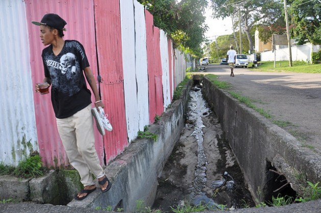 Terry-Ann Lewis fears that this drain which runs through her community could lead to catastrophe if it is unable to handle heavy storm runoff. Credit: Desmond Brown/IPS
