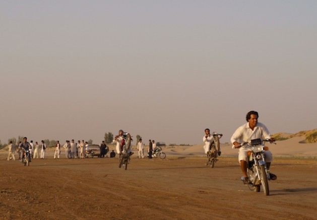 Baloch youngsters ride their motorbikes along the dry bed of the Helmand River. The total lack of economic and social opportunities pushes them to illegally migrate to neighbouring Iran, seeking a better life. Credit: Karlos Zurutuza/IPS