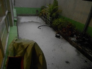 Climate change is causing violent storms, prolonged droughts and temperature extremes. In August 2014, at the height of summer, a hailstorm turned the yard white in this house in the south of Mexico City. Credit: Emilio Godoy/IPS