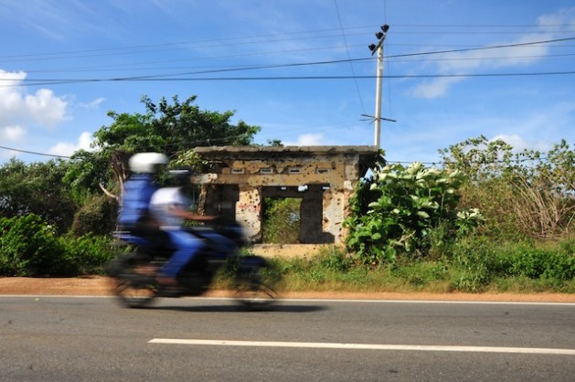 This bullet-pocked building, located in the Pallai area some 35 km south of Sri LankaÃ¢Â€Â™s northern Jaffna town, stands in contrast to the newly paved road, freshly laid rail tracks and modern buildings cropping up around it. Credit: Amantha Perera/IPS