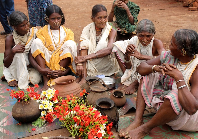 A group of priestesses discuss their plans before setting off in search of ‘vanishing’ millet varieties from a neighbouring village in eastern India. Credit: Manipadma Jena/IPS