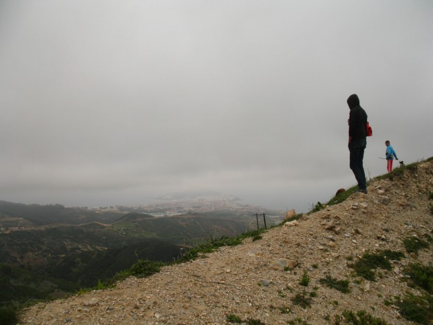 Migrants looking down from the mountain behind the Spanish enclave of Ceuta in Morocco. Credit: Andrea Pettrachin/IPS