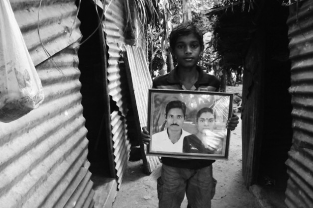 Thavarasa Utharai son Jadusan, 14 years, holds a picture of his missing father and mother. He last saw his father in March 2009. Credit: Amantha Perera/IPS