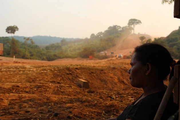 A local small farmer, Rosineide Maciel, watches the road improvement works on highway BR-163, which runs past her house in Itaituba municipality in the northern Brazilian state of Pará. Credit: Fabiana Frayssinet/IPS