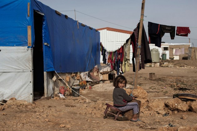 A young Syrian girl sits on a broken chair by her tent in Faida 3 camp, an informal tented settlement for Syria refugees in Bekaa Valley, Lebanon.  Credit: UNICEF/Alessio Romenzi