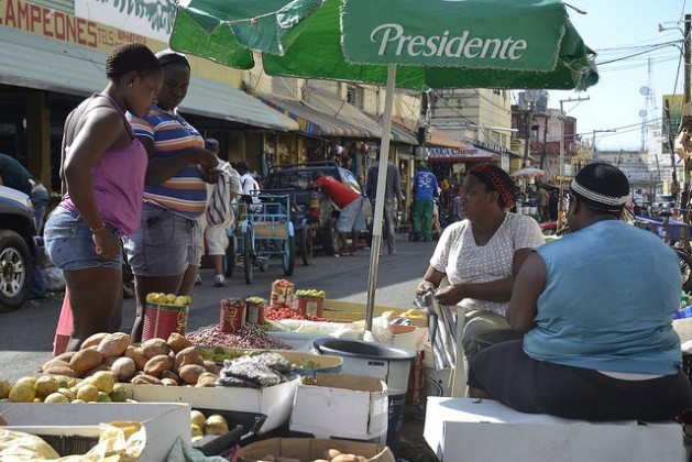 Two women selling fruit, grains and vegetables in the Little Haiti street market in Santo Domingo, the capital of the Dominican Republic. They allowed their picture to be taken but preferred not to talk about their situation. Fear is part of daily life for Haitian immigrants in this country. Credit: Dionny Matos/IPS