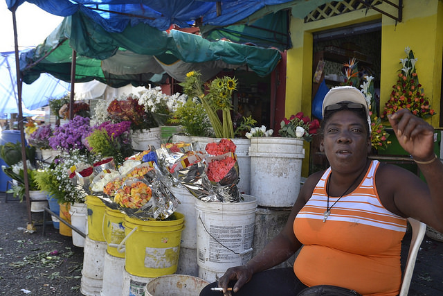 Antonia Abreu, one of the few street vendors who agreed to talk to IPS about the harsh reality faced by Haitian immigrants in the Dominican Republic, at her street stall where she sells flowers in the Little Haiti neighbourhood in Santo Domingo. Credit: Dionny Matos/IPS