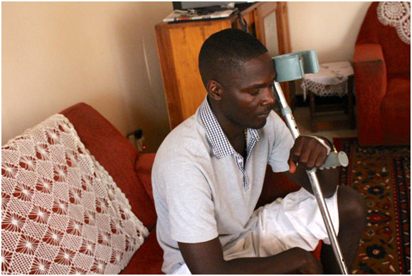 Ugandan journalist Andrew Lwanga, who is still recovering more than one year after allegedly being battered by a police commander while covering a protest. Credit: Amy Fallon/IPS