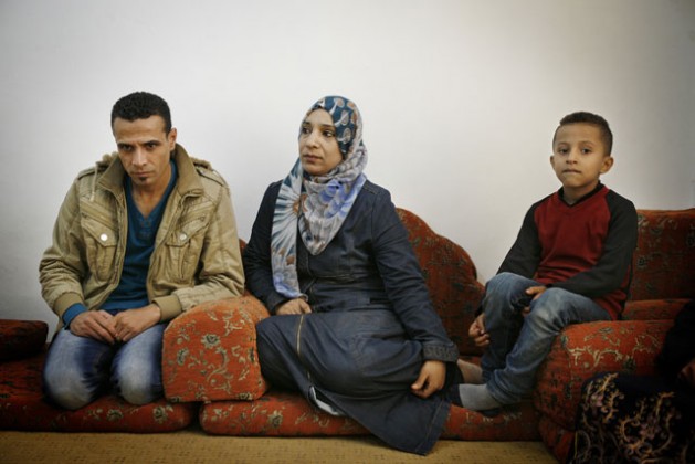 Palestinian refugees from Syria Iyad Yusef, his wife Ibtisam and their youngest son Noor, sit in a relative's home in Beit Hanoun, Gaza. Credit: Silvia Boarini/IPS