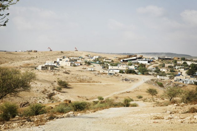 A view of the unrecognised Bedouin village of Umm al-Heran, slated for demolition along the nearby village of Attir. In the background, Jewish National Fund bulldozers prepare the land for tree planting. The state is forcing the Abu Al Qian tribe to relocate to nearby Hura. Credit: Silvia Boarini/IPS