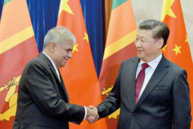 FRIENDS AGAIN BUT ON WHAT TERMS?: Visiting Lankan Prime Minister Ranil Wickremesinghe with China’s President Xi Jinping at Great Hall of the People in Beijing on Friday.