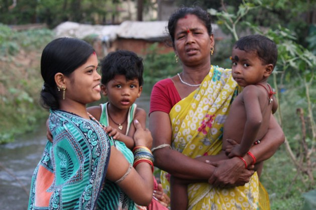 Kalpana Bagha (on left) with son is worried about what Bhubaneswar’s smart city development may have in store for her family.  Credit: Manipadma Jena/IPS