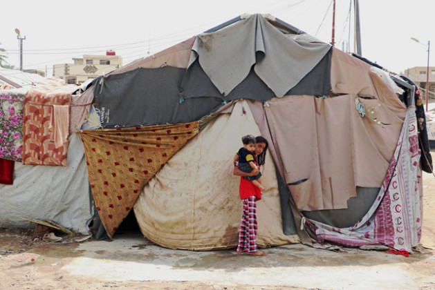 A family living in this tent in Baghdad, Iraq, explains that the camp and the tents were not ready for winter. Credit: WFP/Mohammed Al Bahbahani