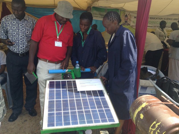 A solar-powered mower on display with its inventors, Kenyan university engineering students Emma Masibo (left) and Lucy Bwire, with their lecturer Peter Wamalwa. The mower was exhibited during the 5th National Science Week that opened on May 16, 2016 in Nairobi. Young people are using innovation to protect the environment and make life easier. Credit: Justus Wanzala/IPS