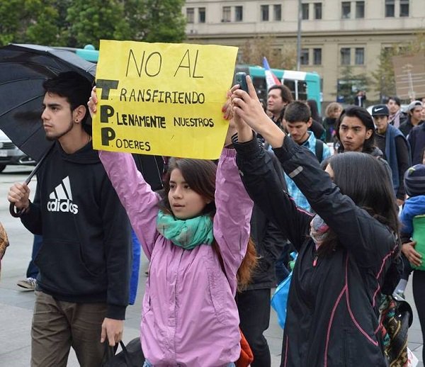 A girl holds a sign saying the TPP means Transferring Fully our Powers, during a protest against the trade agreement in Santiago, Chile. Credit: Courtesy of "A Better Chile without TPP" 
