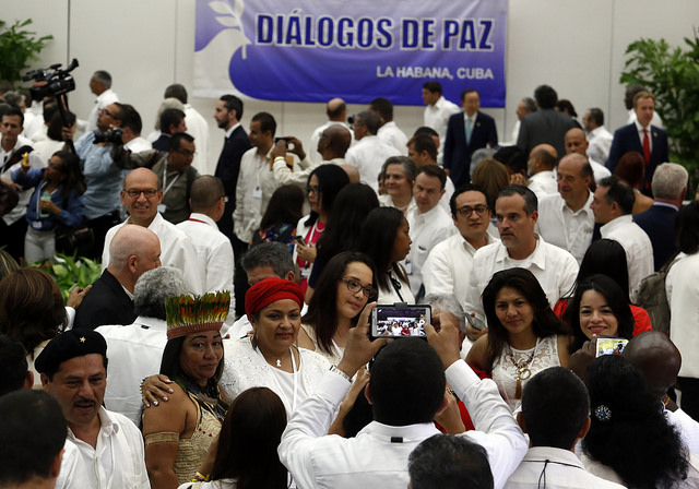 Victoria Sandino, a FARC commander, who headed the guerrillas’ representatives to the gender subcommittee in the peace talks with the Colombian government (second-left, wearing red headscarf), poses with members of civil society during the signing of the definitive ceasefire on Jun. 23 in Havana, Cuba. Credit: Jorge Luis Baños/IPS