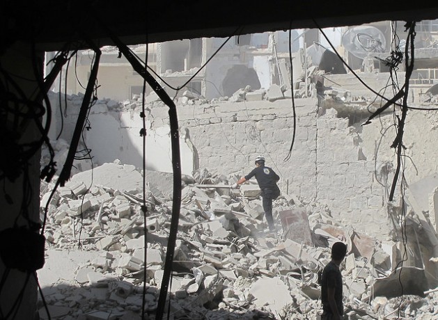 A civil defence team search for survivors after a barrel bomb attack in Aleppo Syria in August 2014. Credit: Shelly Kittleson/IPS