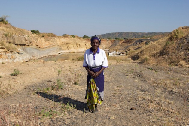 Nagomba E., 75, standing where her house used to be in Mwabulambo, Karonga district. She and her family were told to relocate in 2008 because the land was needed for coal mining. Credit: Lauren Clifford-Holmes for Human Rights Watch