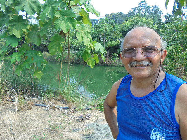  Domingo Mendes stands next to one of the tanks where he holds wastewater from raising pirarucú or arapaima fish, used to irrigate vegetable gardens, fruit trees and açaí palm trees, which he grows on part of his farm in Santa Rita, in northwest Brazil. Credit: Mario Osava/IPS