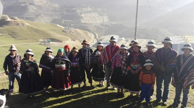 Members of the 16 rural families who refuse to abandon their homes in the village of Taquiruta until the company running the Las Bambas mine compensates them fairly for the loss of their animals, pens and houses. In the background can be seen the biggest mine in Peru. Credit: Milagros Salazar/IPS