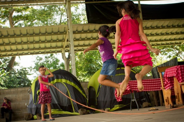Girls skip rope in the camp where they are staying in the town of Caluco, in western El Salvador, in makeshift accommodations on a basketball court. Dozens of families have fled from the neighbouring rural community of El Castaño, owing to the criminal violence and threats from gangs.