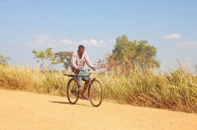 A man rides his bicycle through a dusty village in the Mahavellithanne area, about 350 km northeast of Sri Lanka's capital Colombo, where daytime temperatures were hitting 38C this week. Credit: Amantha Perera/IPS