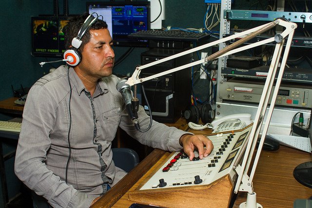 Wilfredo Hernández, during the broadcast of one of the radio news programmes of Izcanal Radio and Television, a project that emerged in 2003 in Nueva Granada, in eastern El Salvador. The community station was the only one to expand towards a TV channel. Credit: Edgardo Ayala/IPS