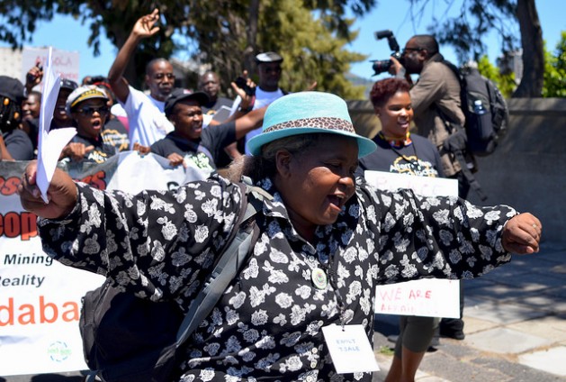 A delegate from the Alternative Mining Indaba dances during a protest march on Feb. 8, 2017. About 450 representatives of civil society mining-affected communities attended the conference in Cape Town. Credit: Mark Olalde/IPS