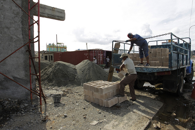 Workers unload materials for the reconstruction of a building damaged by Hurricane Matthew, on the seaside promenade of the historic city of Baracoa, in the eastern province of Guantánamo,  Cuba. Credit: Jorge Luis Baños/IPS