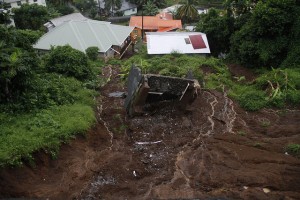 Torrential rains from trough systems in St. Vincent and the Grenadines in November 2016 resulted in landslides like this one, which swept one structure away and threatened nearby houses. Credit: Kenton X. Chance/IPS