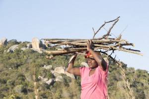 Constance Huku, 29, of the rural town of Masvingo in southeastern Zimbabwe, carries a pile of wood on her head. Credit: Sally Nyakanyanga/IPS