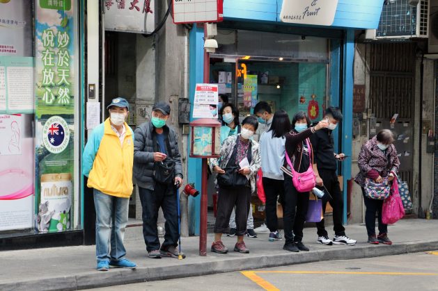 People wearing face masks at a Bus stop in Macau, China near a public hospital. This week’s 73rd World Health Assembly had member states adopt a resolution to review the global response to the coronavirus pandemic. Photo by Macau Photo Agency on Unsplash