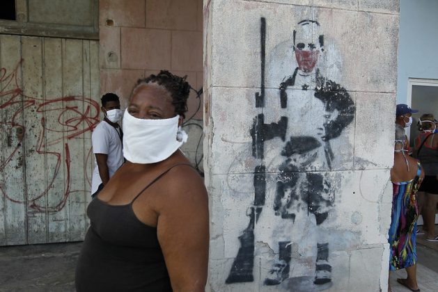 A woman wearing a mask to protect herself from the contagion of the coronavirus, waits to buy food outside a store in the Playa municipality, in Havana, Cuba. As of Tuesday, Jun. 16, 1.7 million people have been affected by the virus across Latin America and the Caribbean -- doubling in the last week. Credit: Jorge Luis Baños / IPS