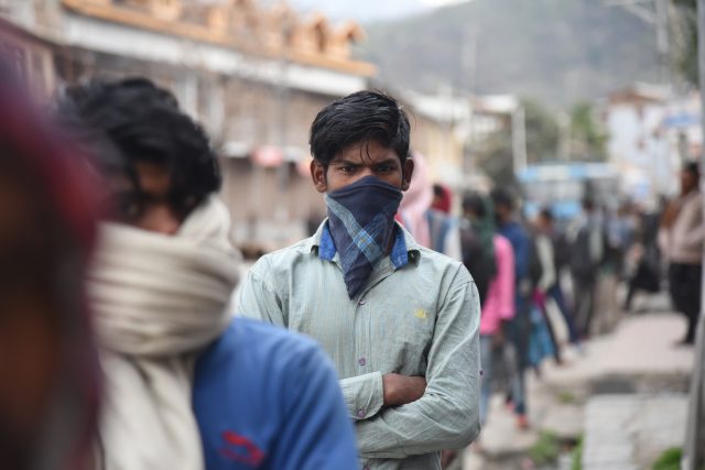 Migrant worker Siraj Alam waits to board a bus in India’s Srinagar City to return to his hometown in Bihar. The closure of factories due to COVID-19 has forced millions of labourers like him to leave the cities and return to their rural homes. Credit: Umer Asif/IPS